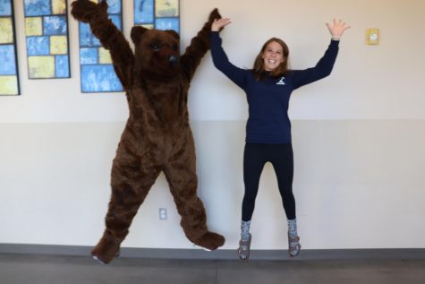Our very own Hannah Miller (11) jumps around with the school mascot.