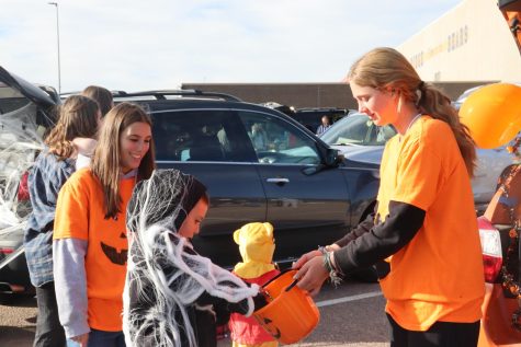 Emily Miller (12) and Maggie Mulloy (11) seen pictured at Trunk-or-Treat with their pumpkin themed car. Photo by Hannah Miller.