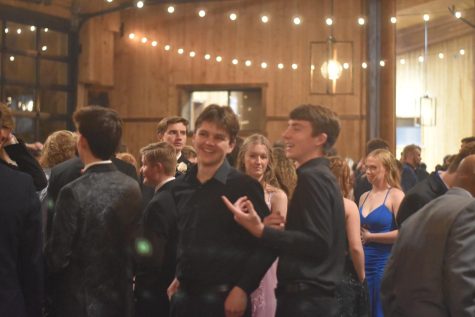 Friends talk and smile while prom takes place. Photo taken by Julia Reish 