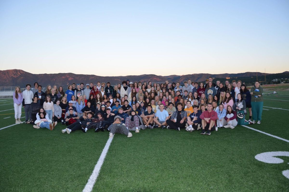Class of 2024 poses for a picture with the sunrise